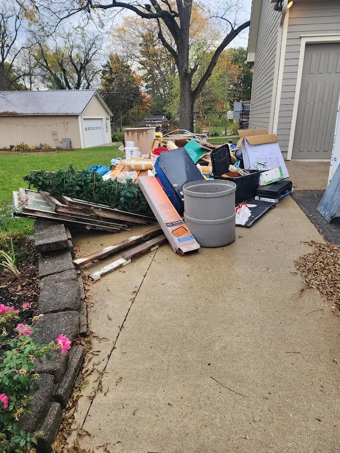 Dumpster being loaded with debris for Residential Dumpster Rental in Jensen Beach